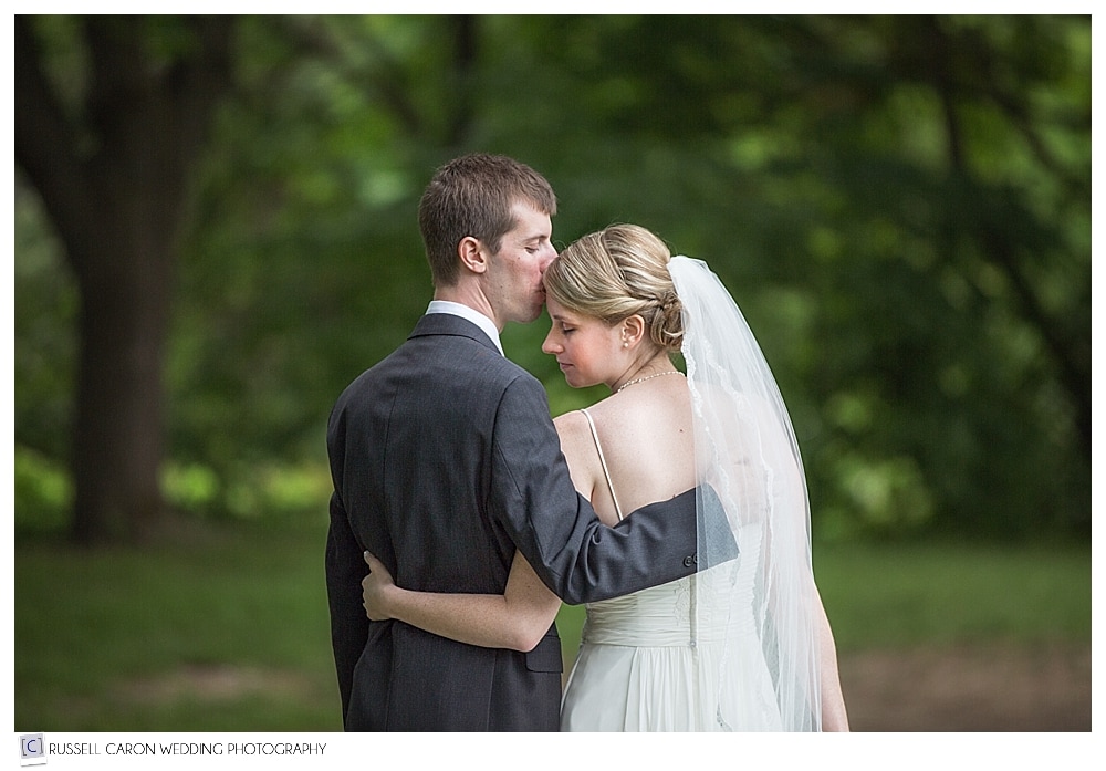 groom-kissing-bride-on-forehead