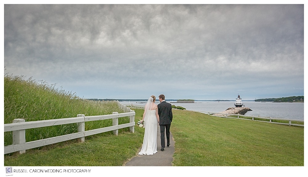 bride-and-groom-walking-at-fort-preble-during-their-south-portland-wedding