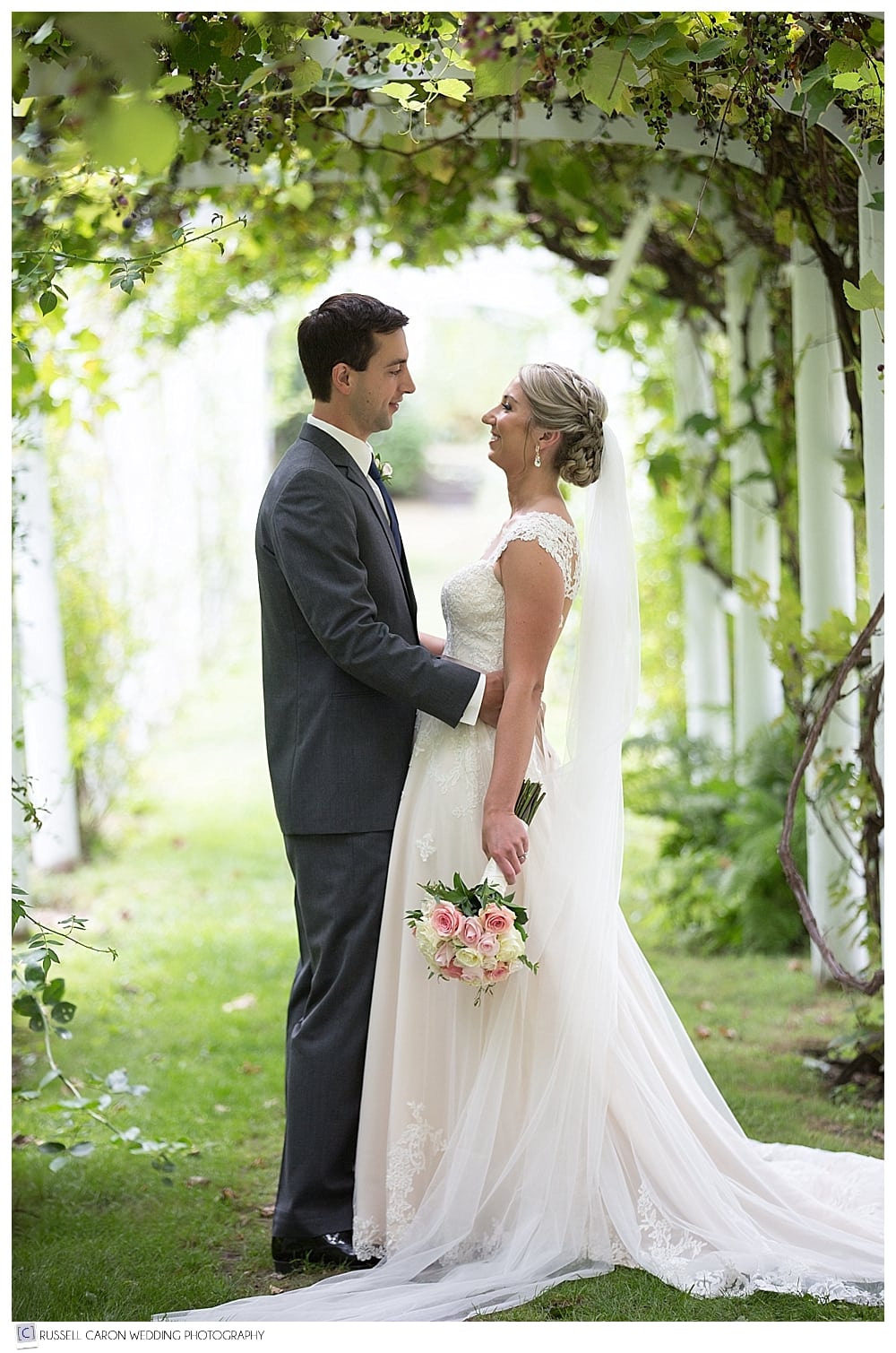 bride and groom in grape arbor