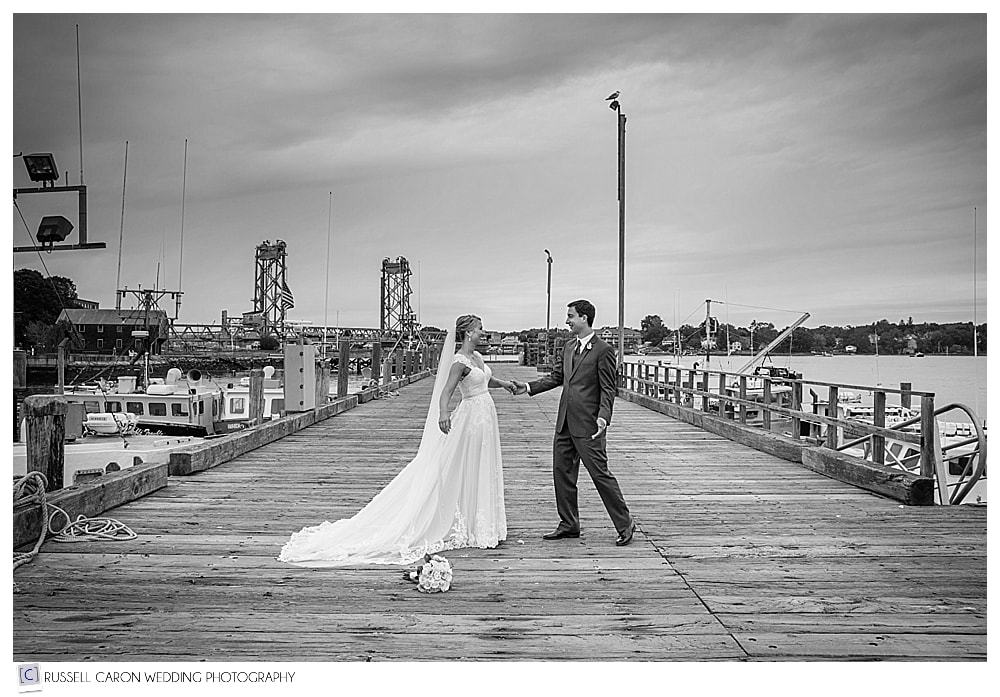 bride and groom dancing on fishing dock