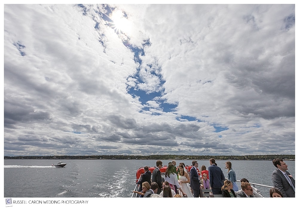 wedding guests onboard boat on a beautiful Maine spring day