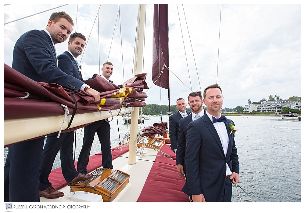 groom and groomsmen on sailboat