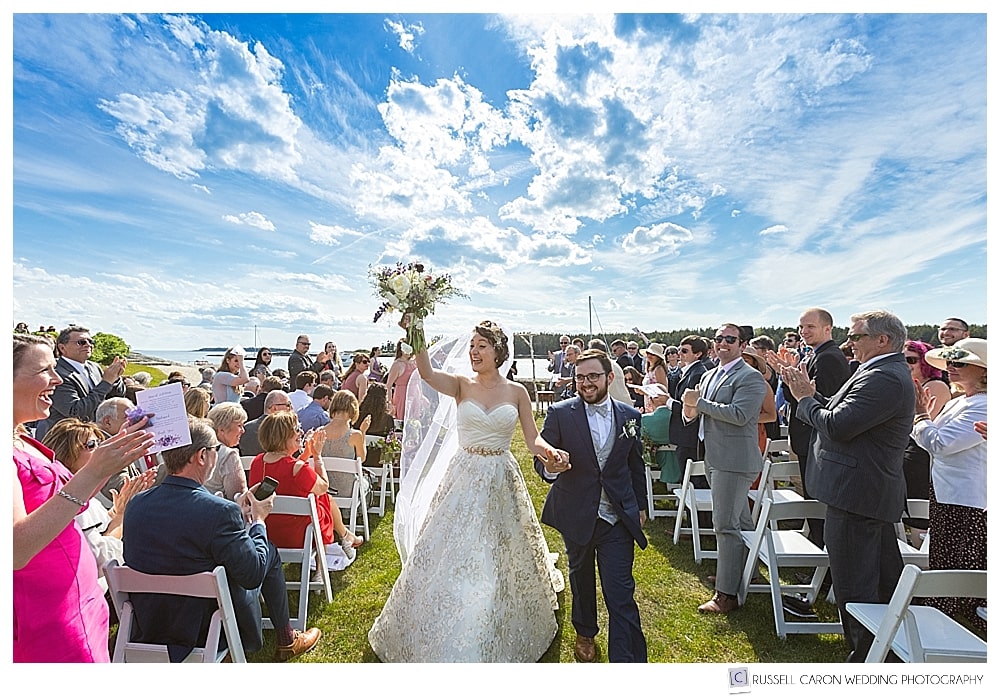 bride and groom during their recessional at their oceanside maine wedding at sebasco harbor resort, phippsburg, maine