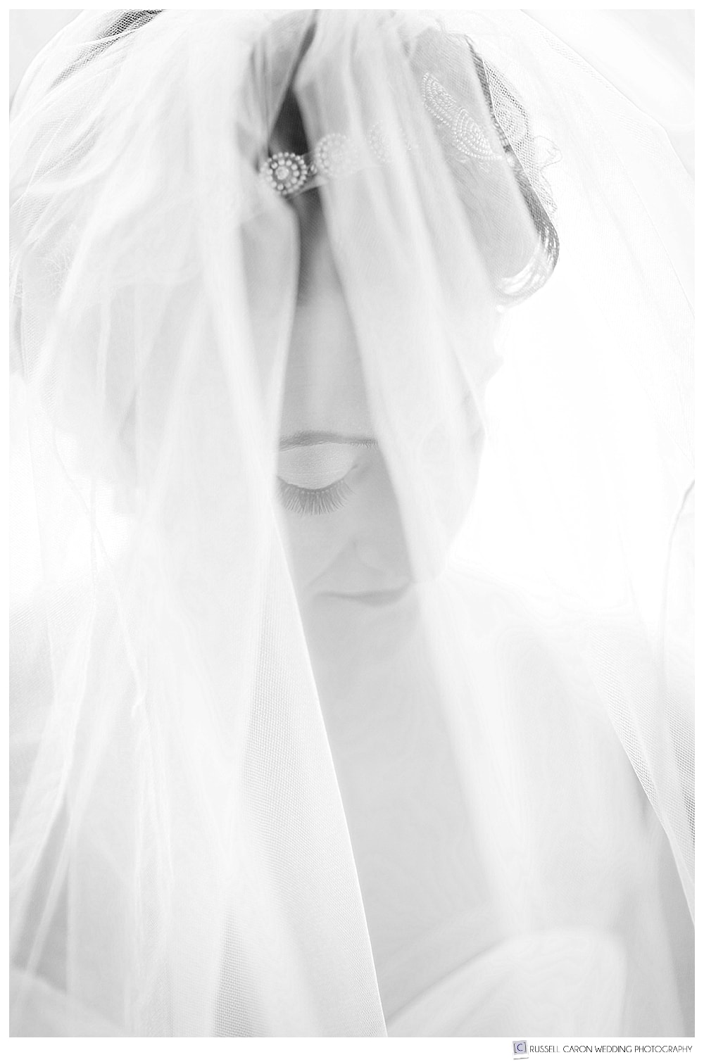 black and white photo of bride behind her veil