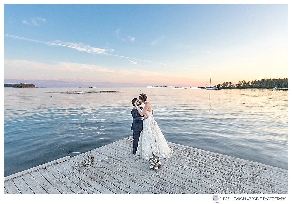 bride and groom on the sebasco harbor resort dock at sunset