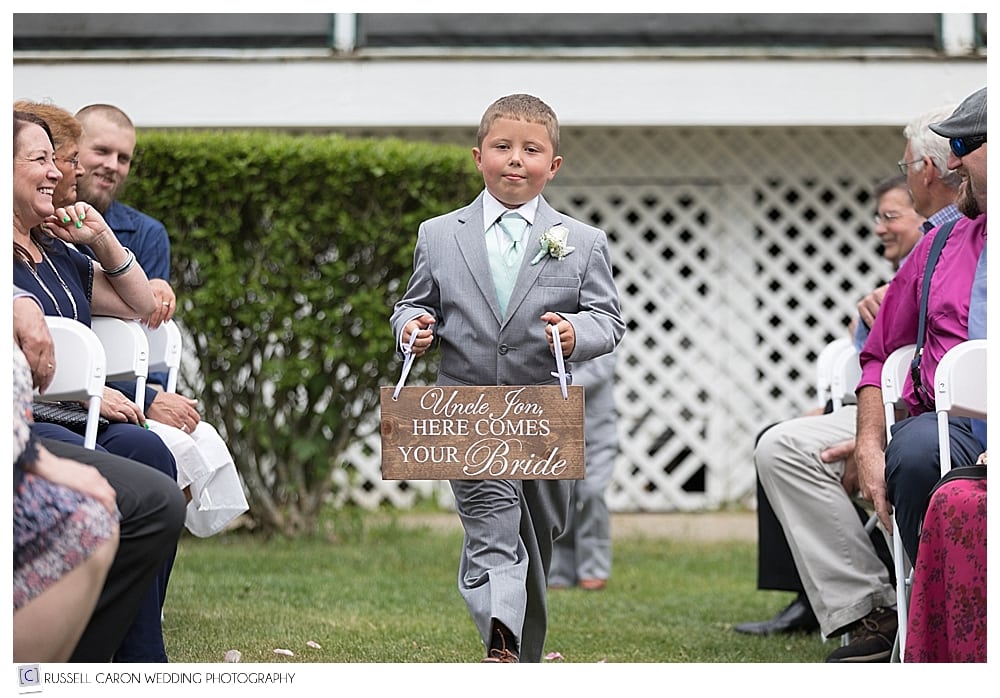 Ring Bearer walking down the aisle with sign