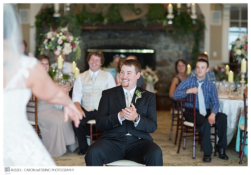 groom-sitting-during-bride's-dance