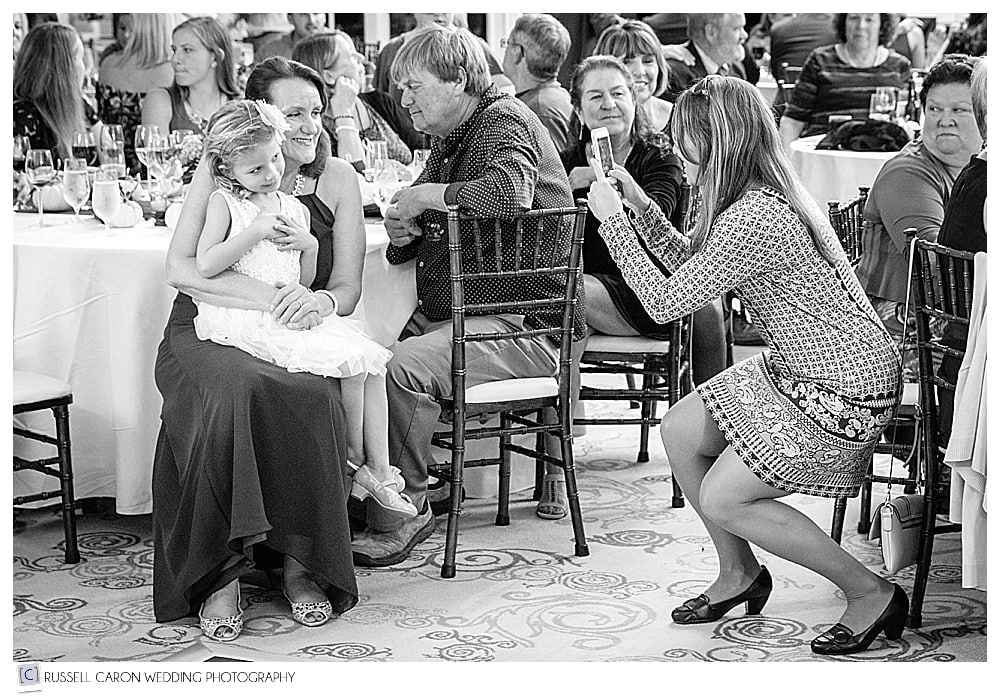 wedding guest takes a photo during the reception
