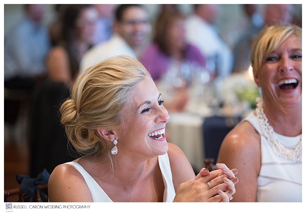 bride laughing during toasts