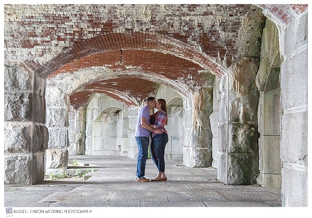 man and woman standing together in Fort Popham, during Popham Beach engagement session