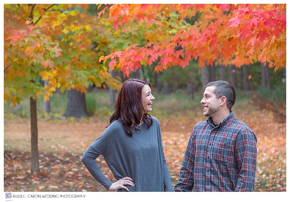 couple laughing in beautiful fall foliage