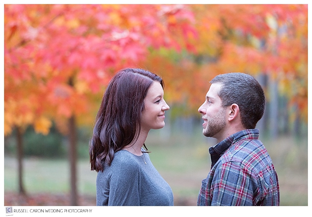couple looking at each other in maine fall foliage