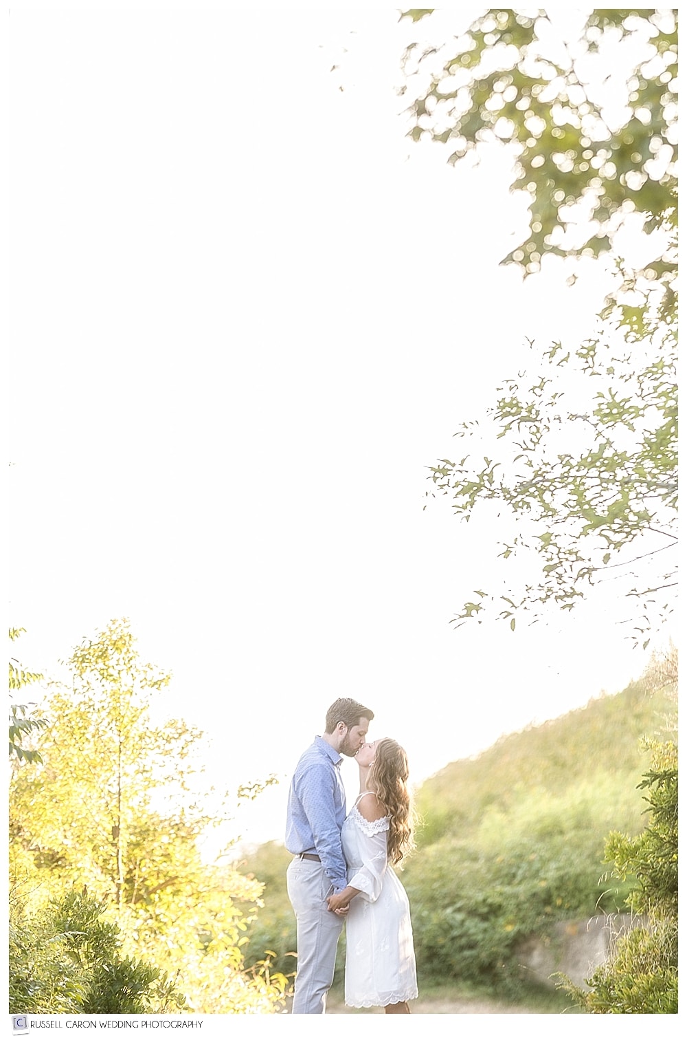 couple kissing in beautiful light, during Real Maine Wedding 2017 Engagement
