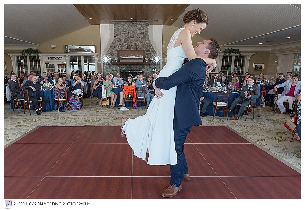 Groom lifts bride during first dance