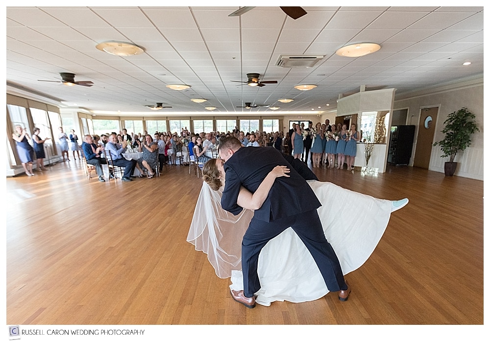 Groom dips bride during first dance