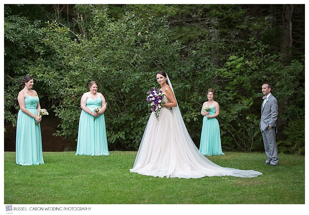 bride surrounded by bridesmaids and man of honor