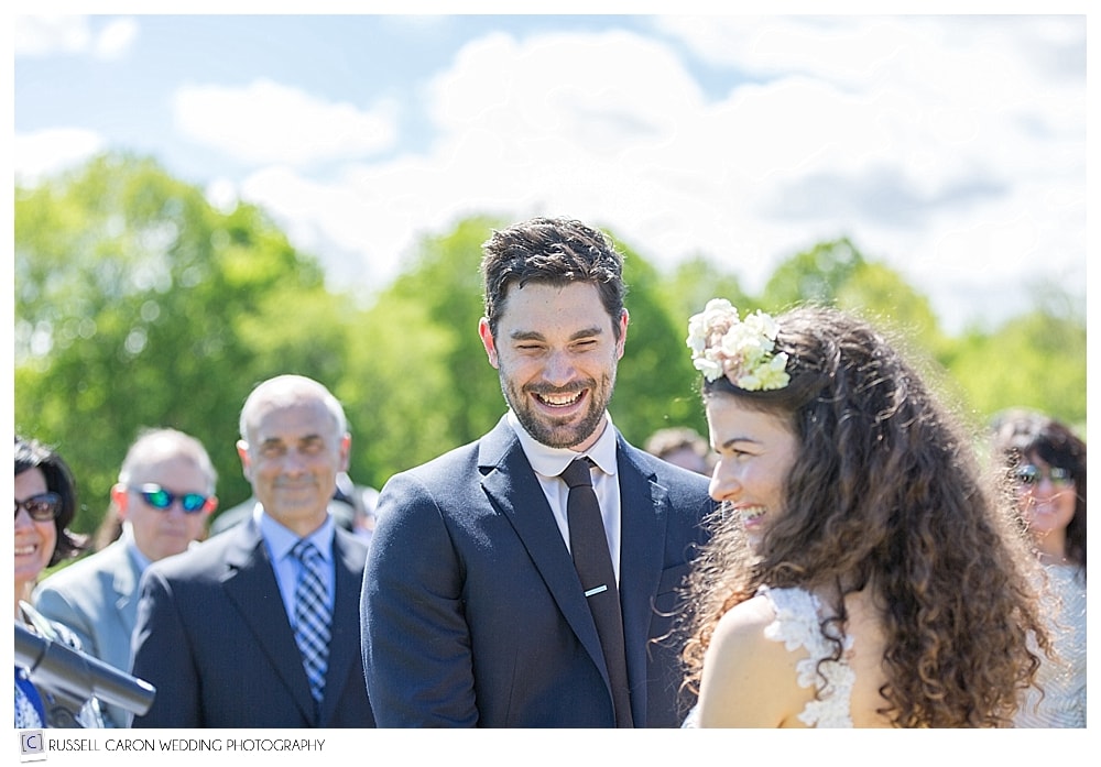 bride and groom smiling during outdoor wedding ceremony