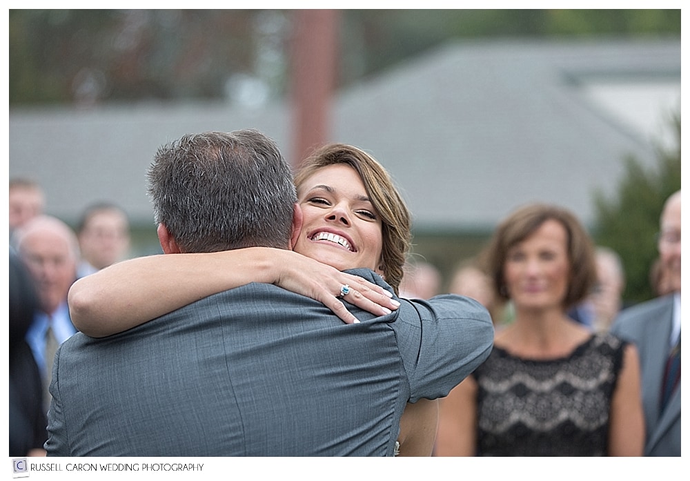 bride hugs her father after he walks her down the aisle