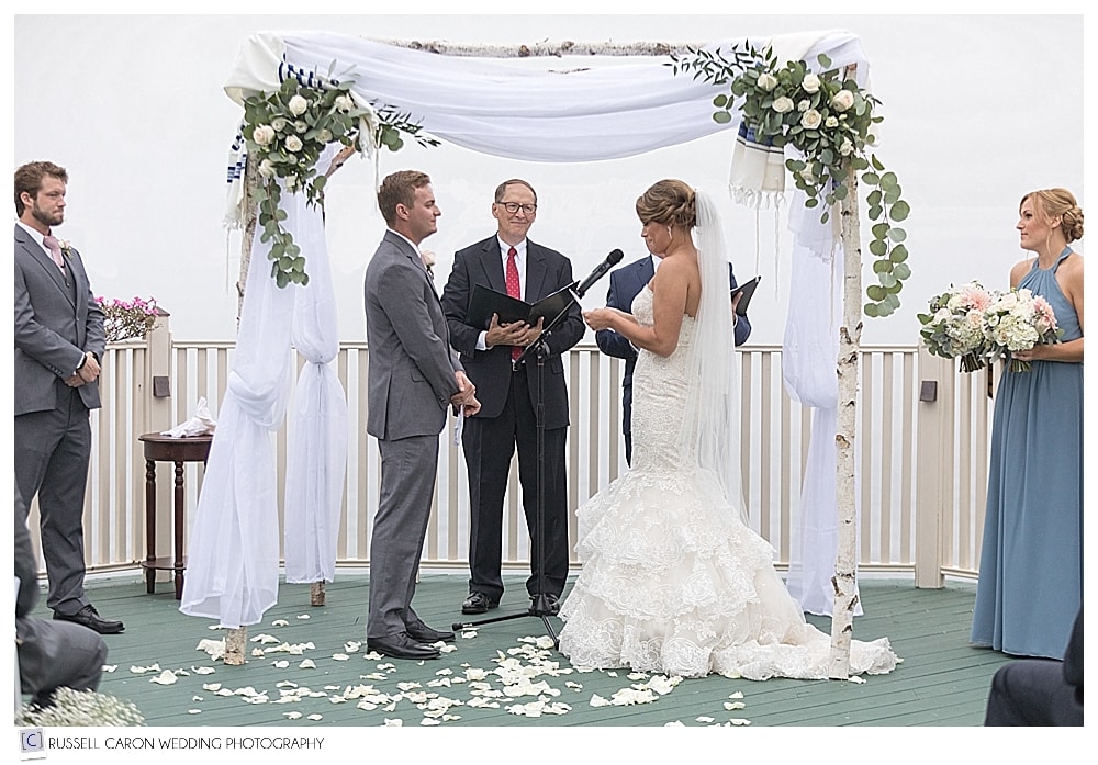 bride reads her vows during wedding ceremony