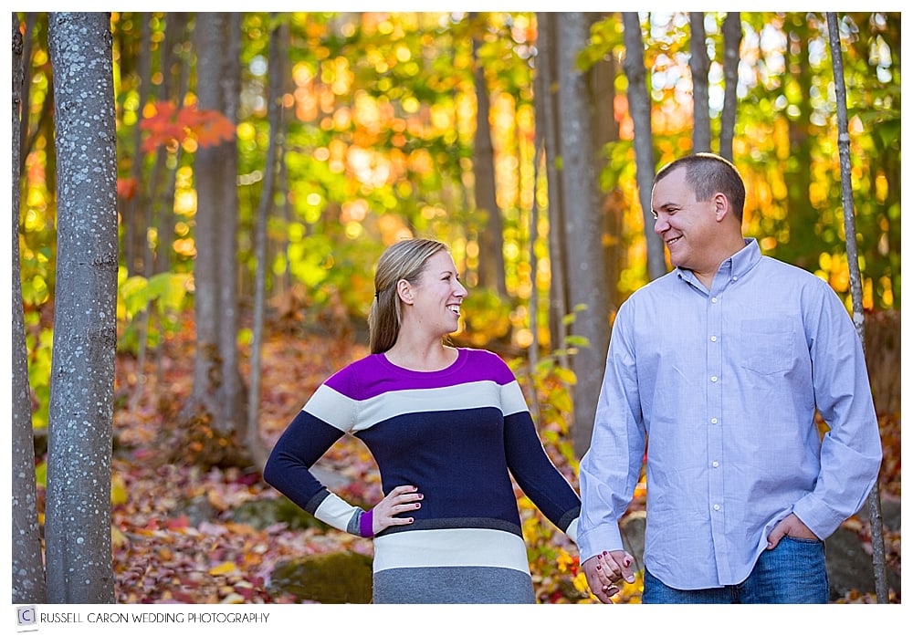 couple standing amid the fall foliage