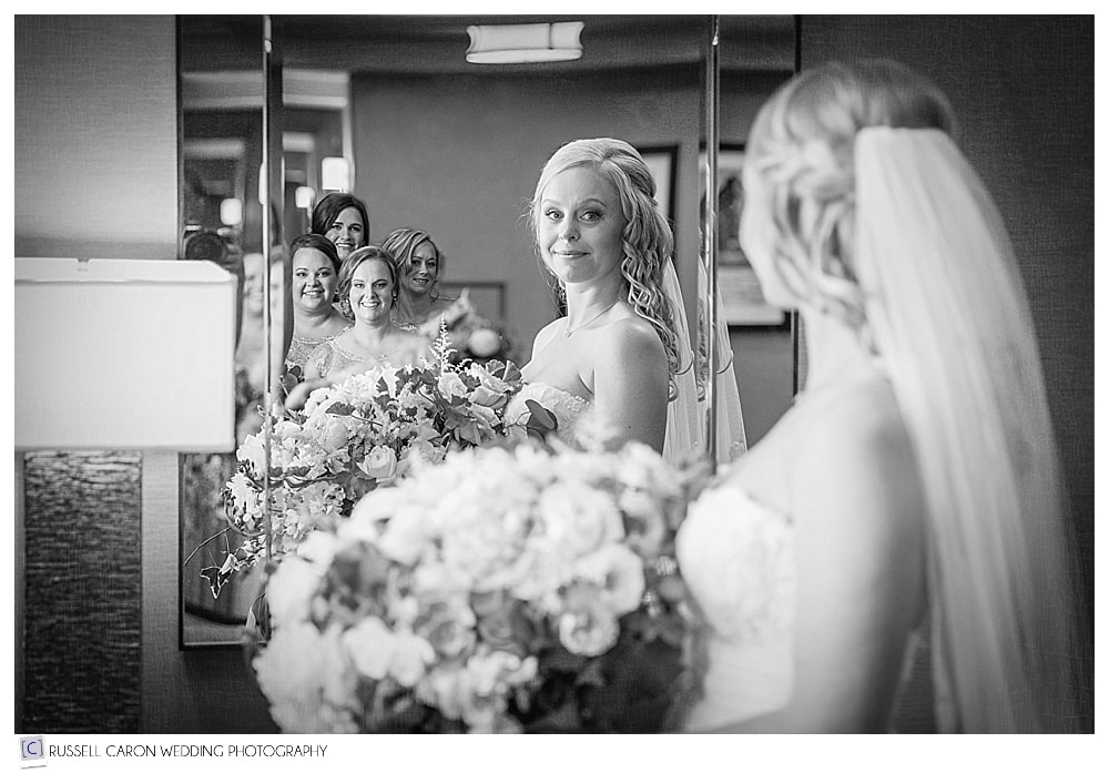 bride and bridesmaids reflected in mirror