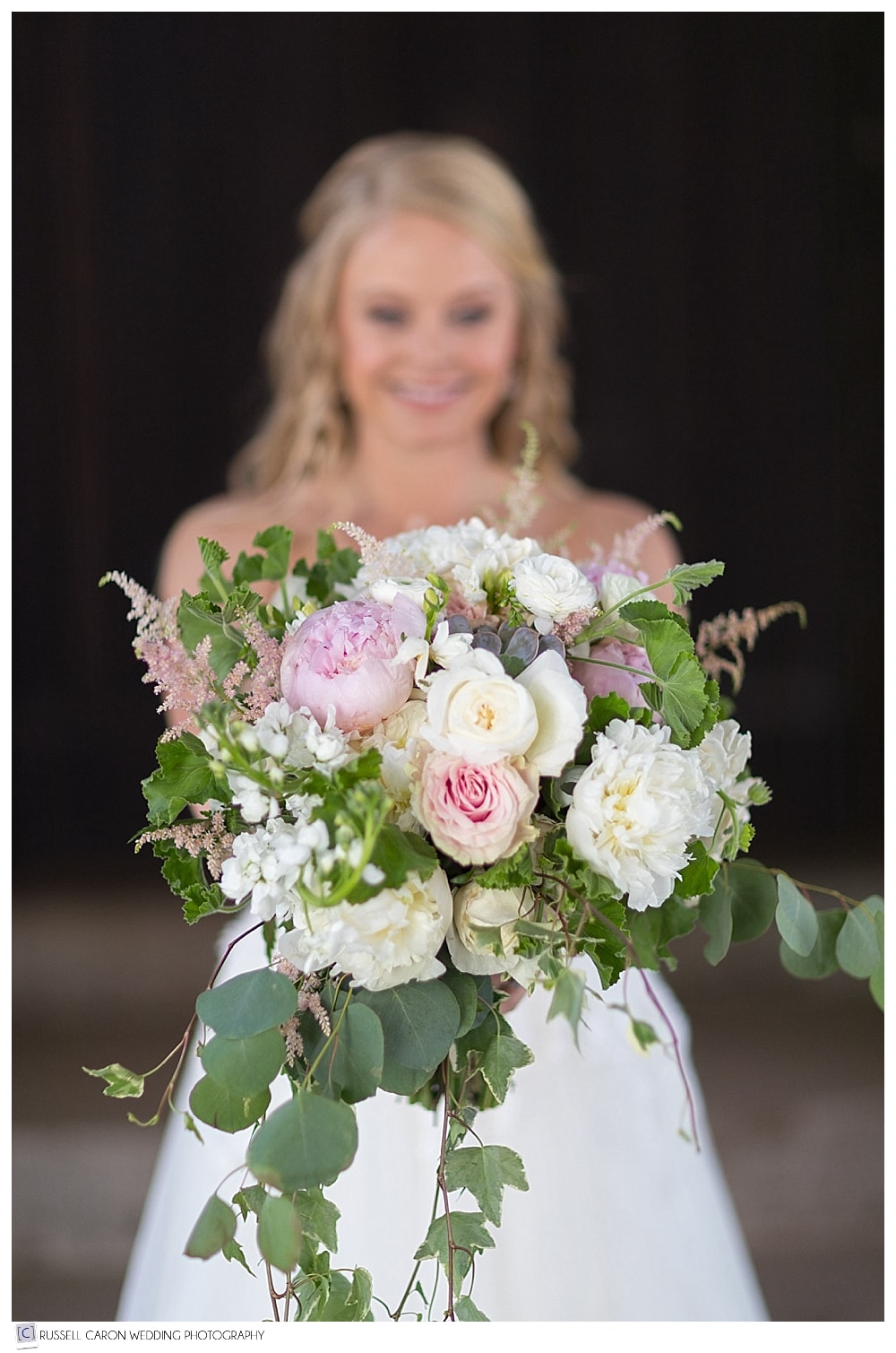 bride holding bridal bouquet in front 