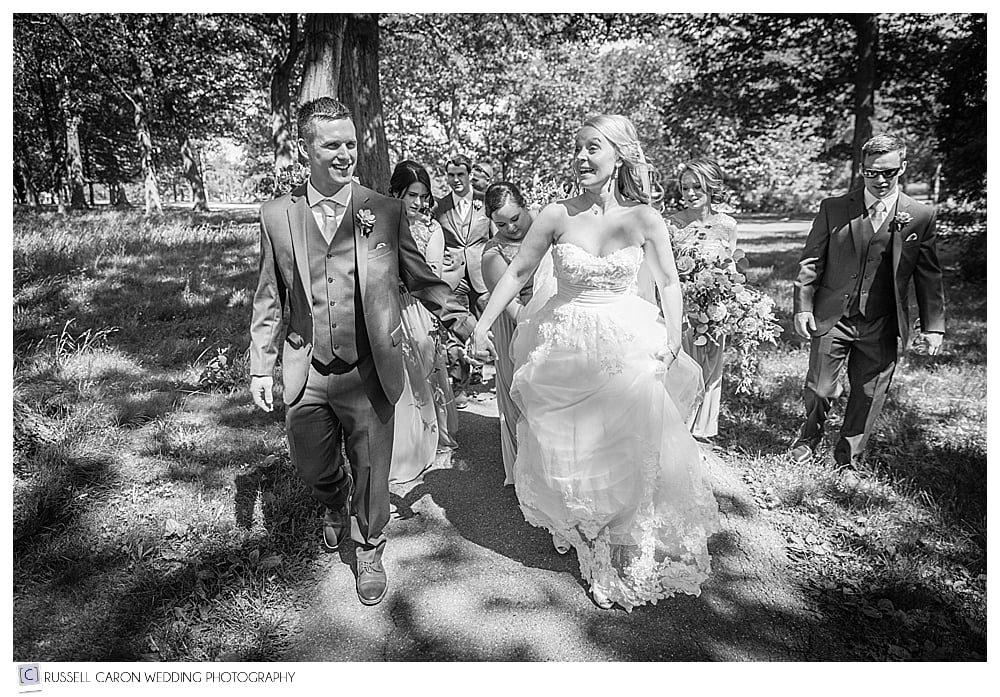 Bride and groom walking hand in hand in Deering Oaks Park, Portland Maine