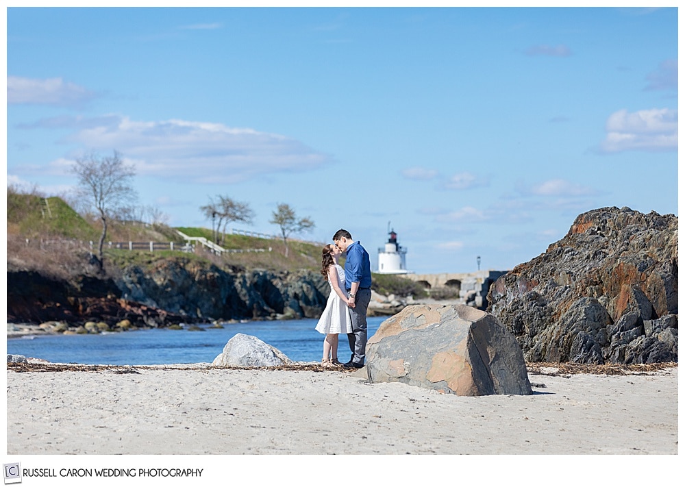 a couple is kissing at their willard beach engagement 