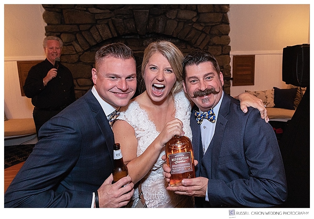 bride and groom laugh with a friend