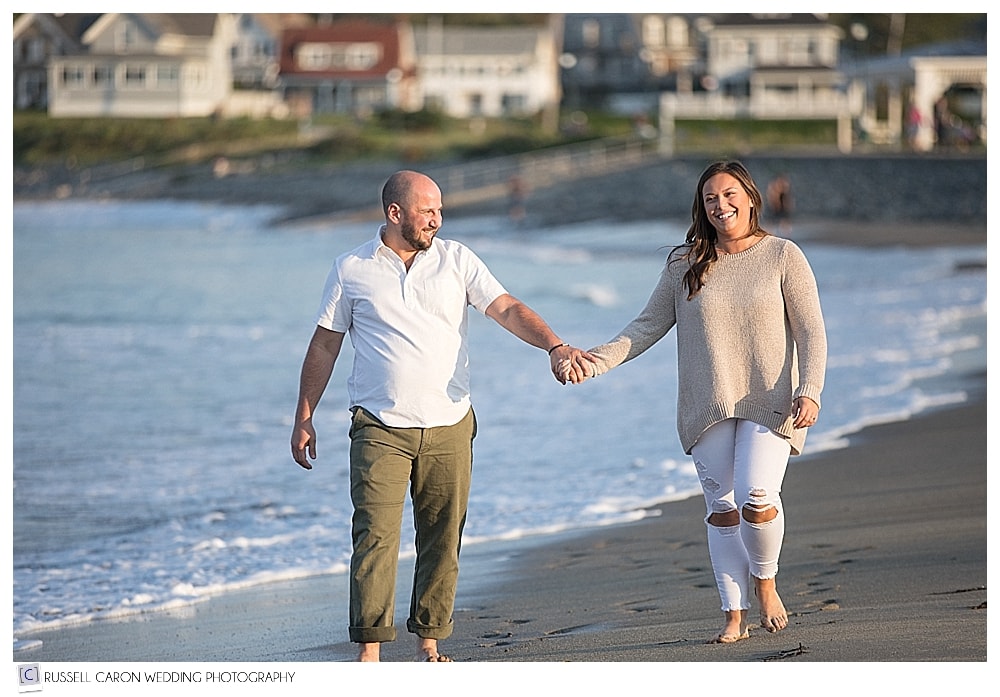 couple walking hand-in-hand during York Harbor engagement session