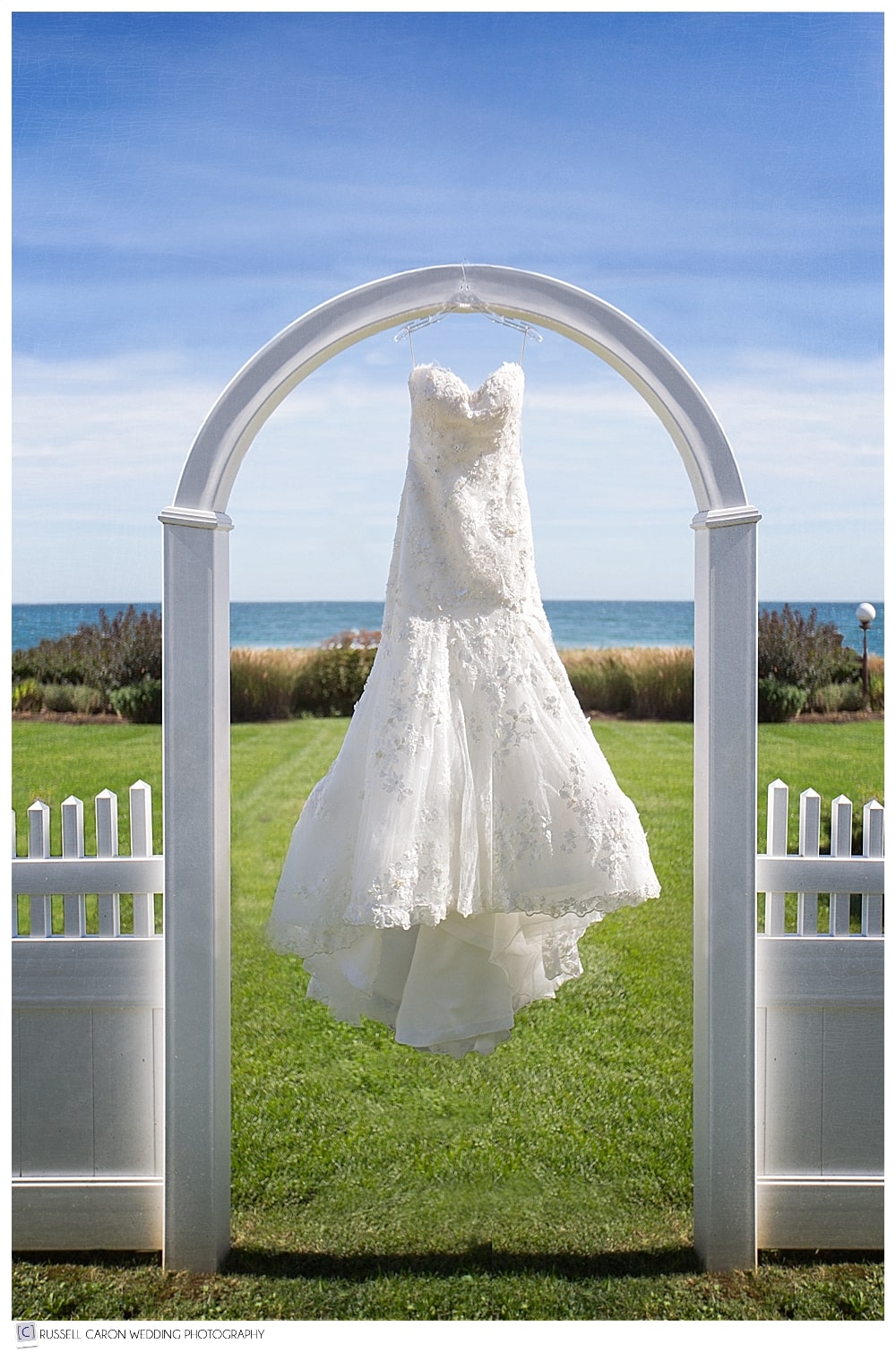 wedding dress hanging in archway