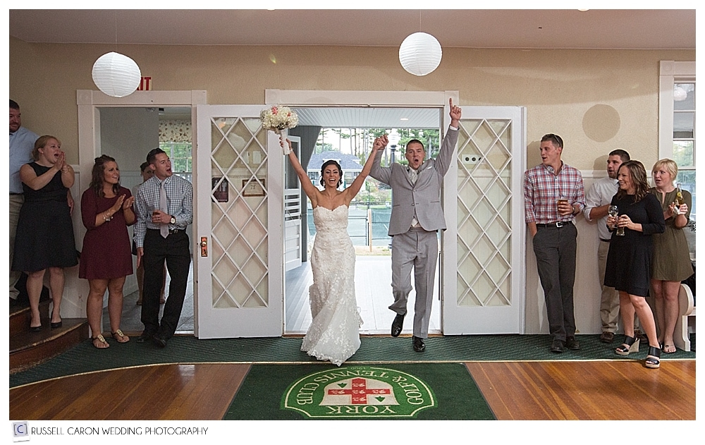 bride and groom enter their wedding reception