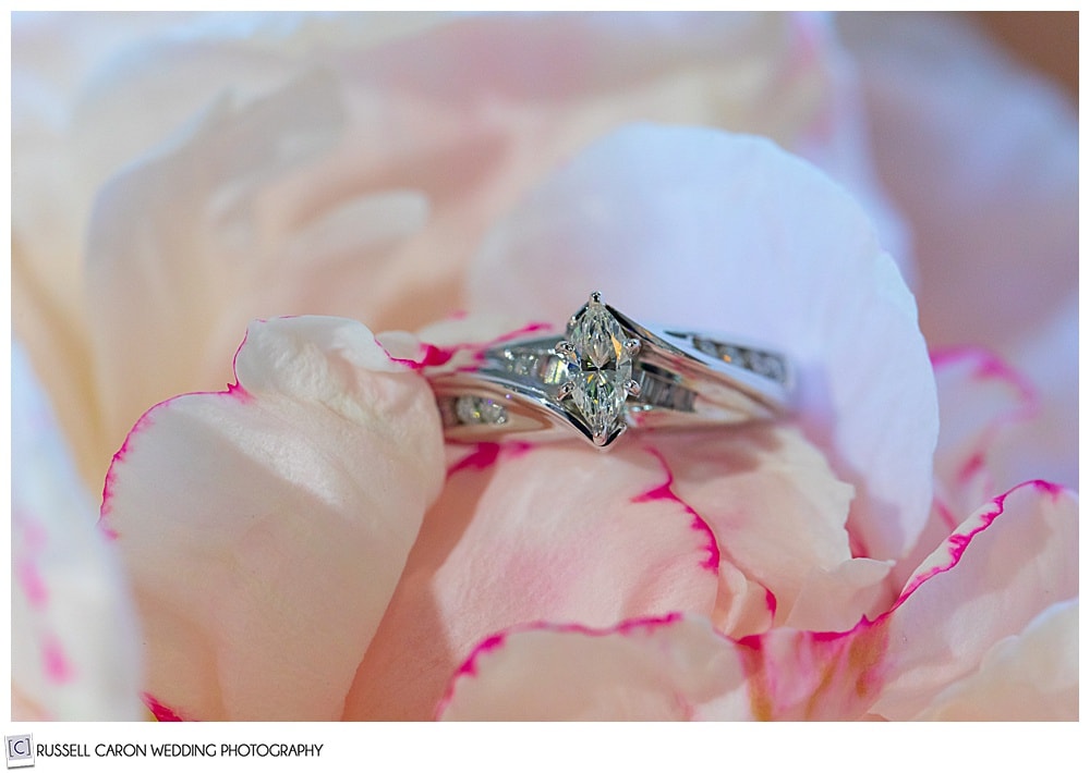 diamond engagement ring on a pink peony