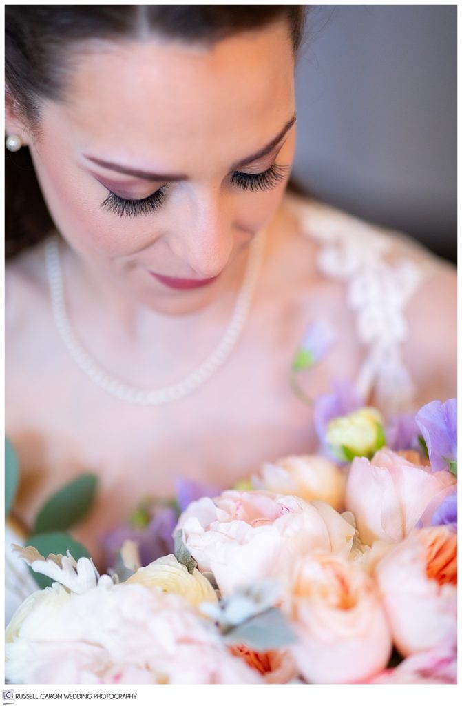 bridal portrait of bride looking down at her bouquet