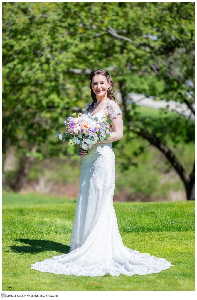 full length bridal portrait of a bride outside on a green lawn