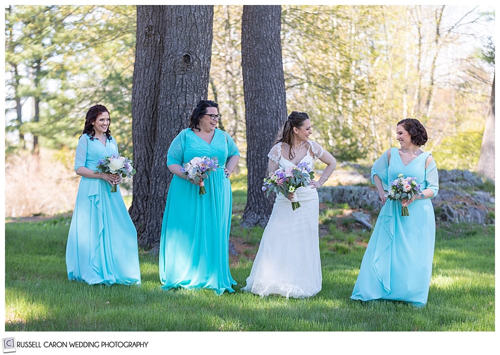 bride standing with bridesmaids in turquoise dresses