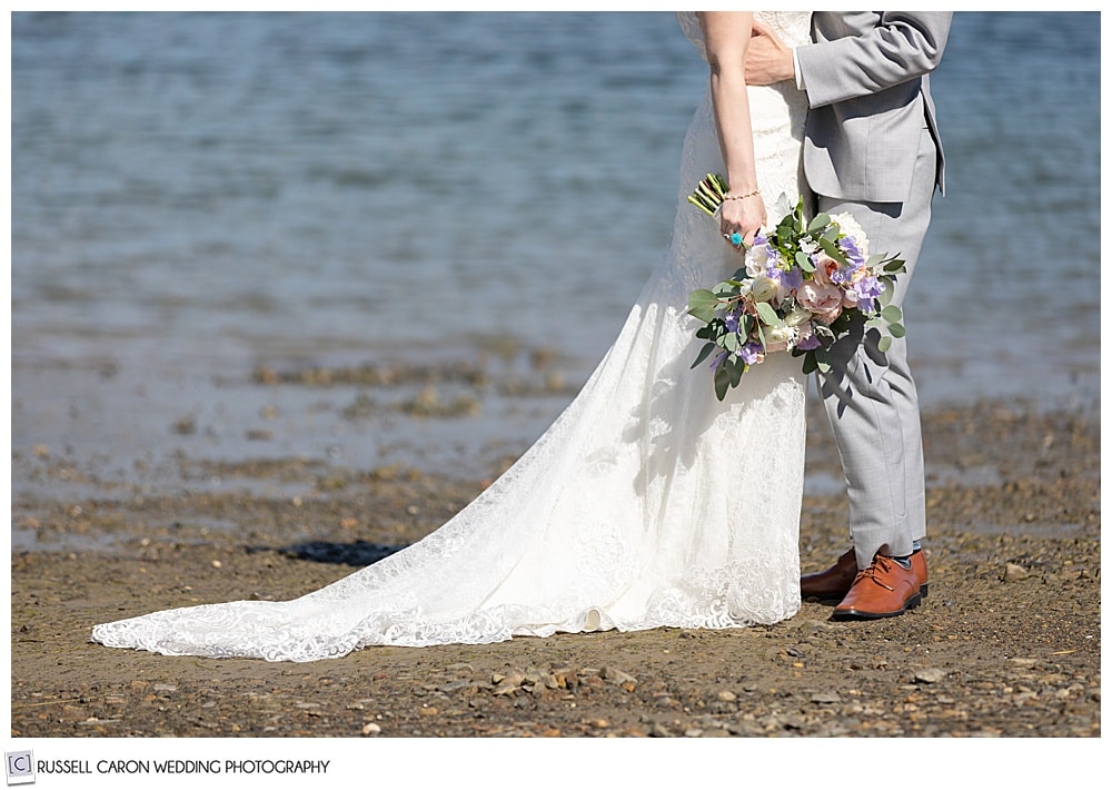 bride and groom at the water's edge