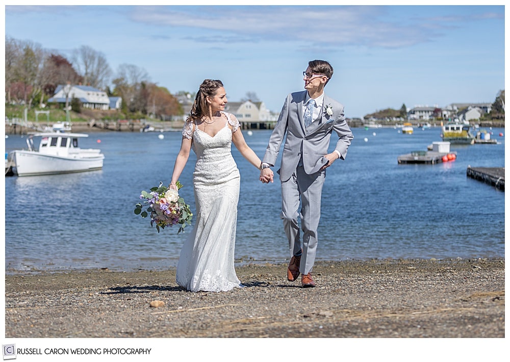 bride and groom walking hand in hand at a beach on the York River, York, Maine