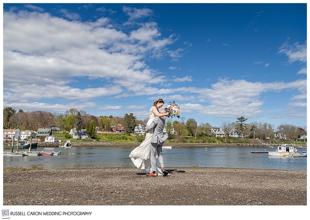 groom picking up his bride on the York River, York, Maine