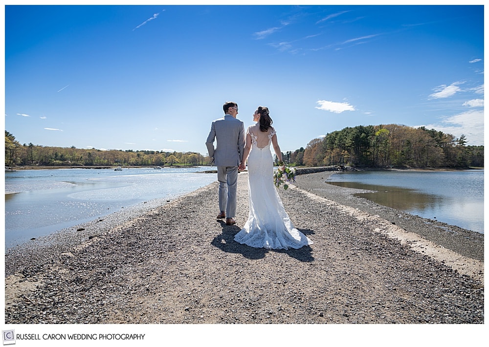 Bride and groom walking on the path to the Wiggley Bridge, York, Maine