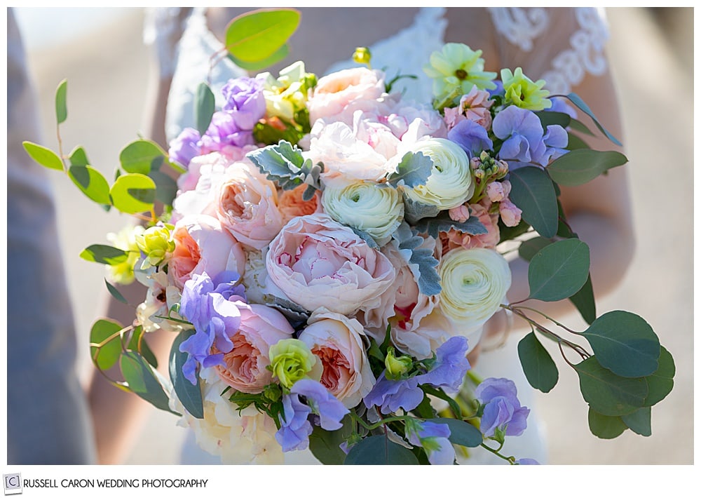 beautiful bridal bouquet with sweet pea, ranunculus, and eucalyptus