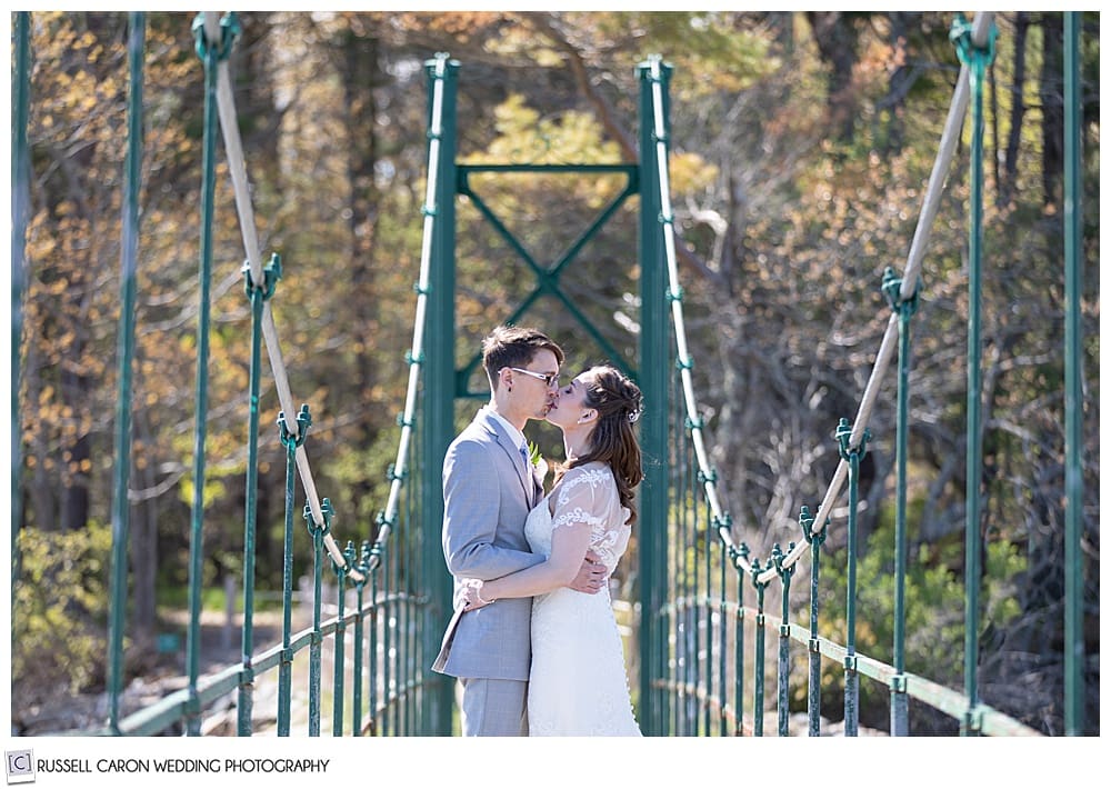 bride and groom kissing on the Wiggley Bridge, York, Maine