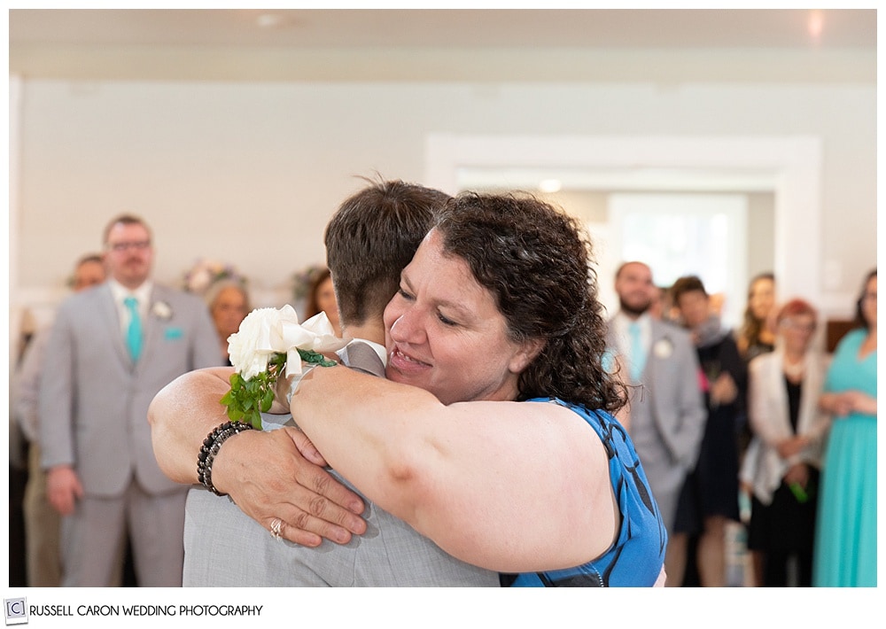 woman hugging her son during the mother son dance