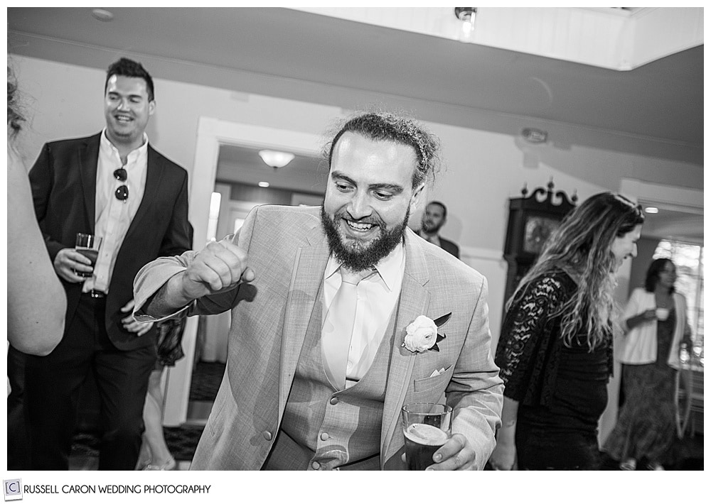 black and white photo of man dancing at a wedding reception