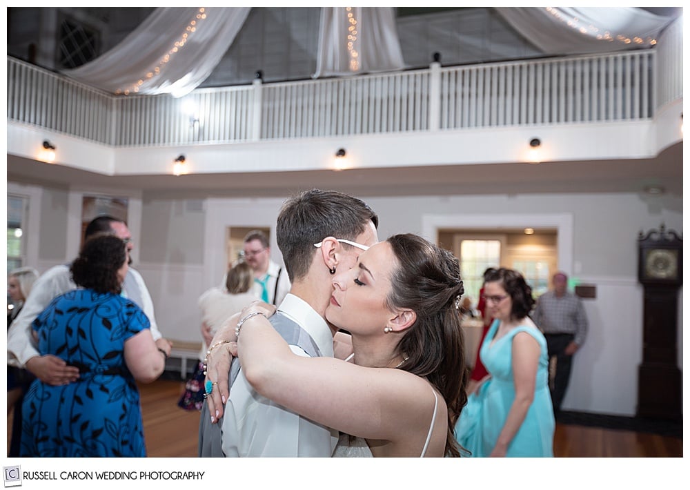 bride and groom holding each other and dancing