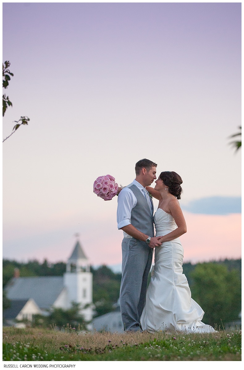 Bride and groom during beautiful sunset at Popham Beach, Maine
