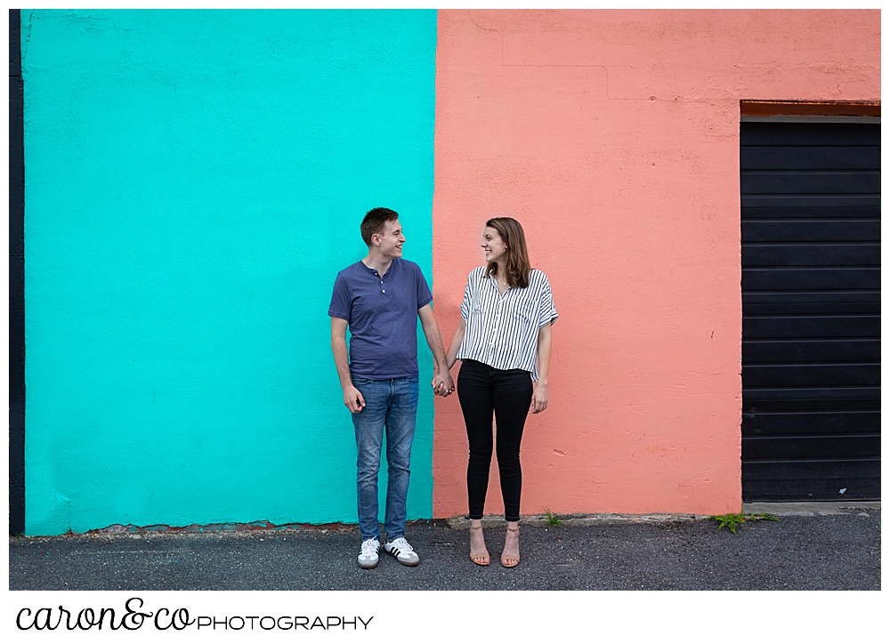 man and woman standing in front of a colorful wall in Southern, Maine, Southern Maine wedding photographers