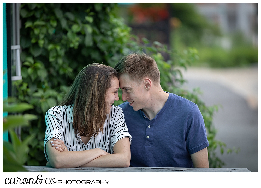 man and woman sitting side by side, their foreheads together. Portland, Maine wedding photographers