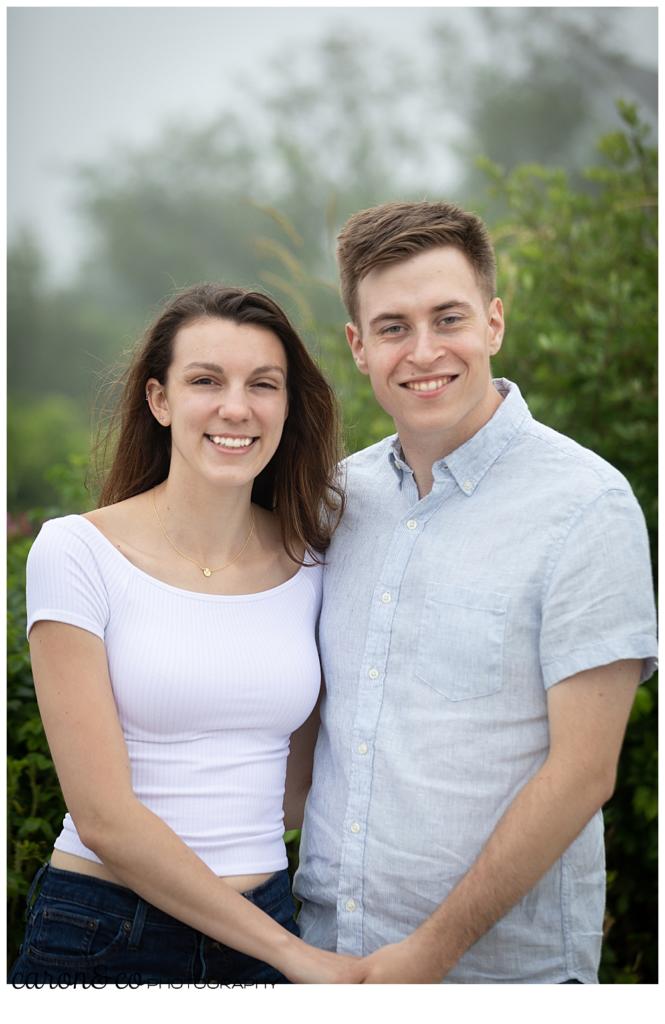 man and woman standing side by side, looking at the camera, dreamy Maine engagement session