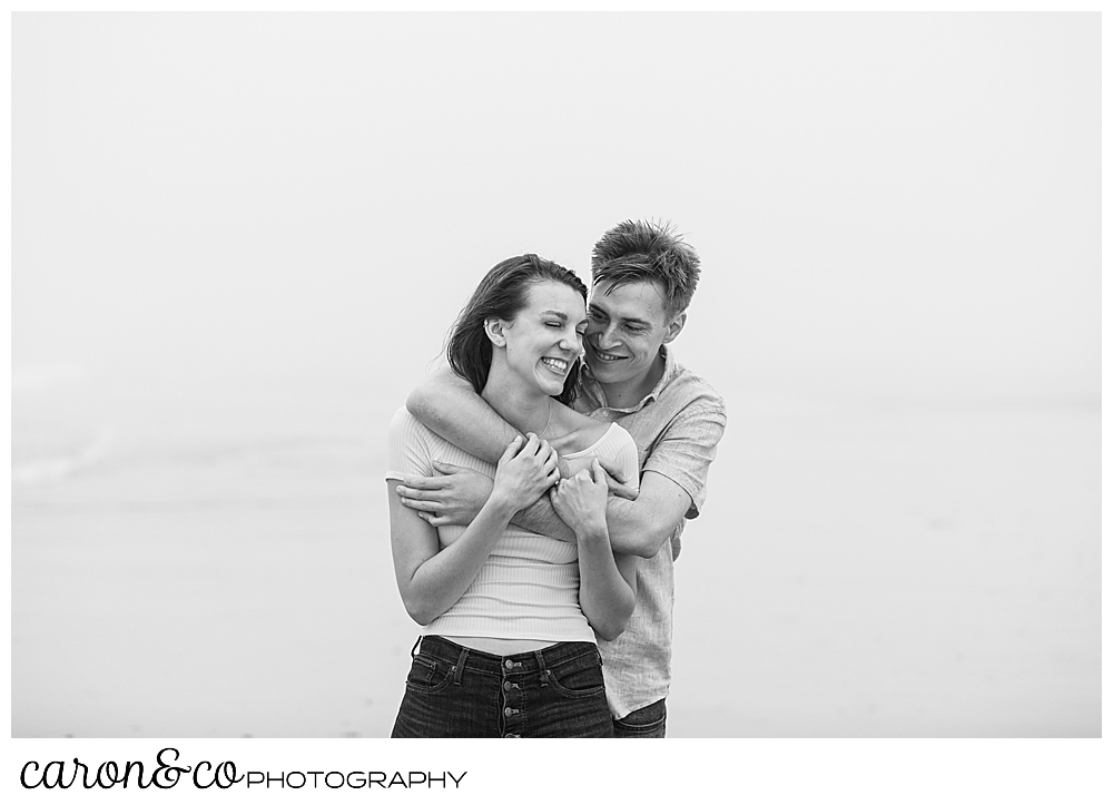 black and white photo of a man and woman hugging each other